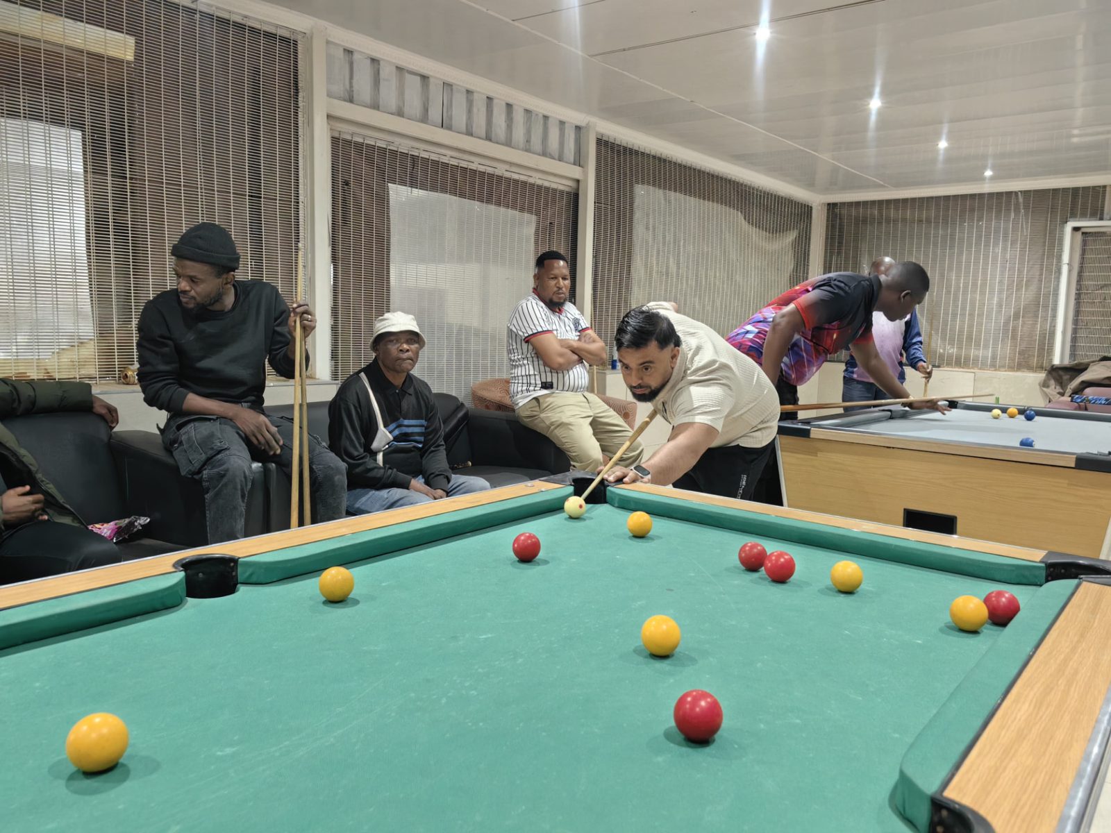 Members playing and watching frames during a club evening
